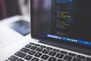 Laptop with code on screen.