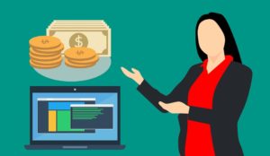 Woman pointing to pile of money and a laptop.