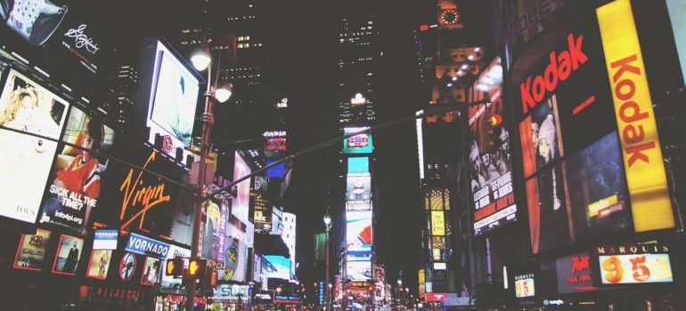 A city street filled with billboards and commercials.