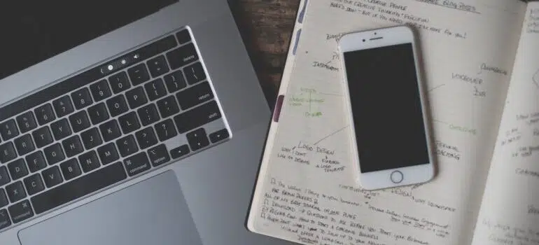 An image of laptop and mobile phone turned off.