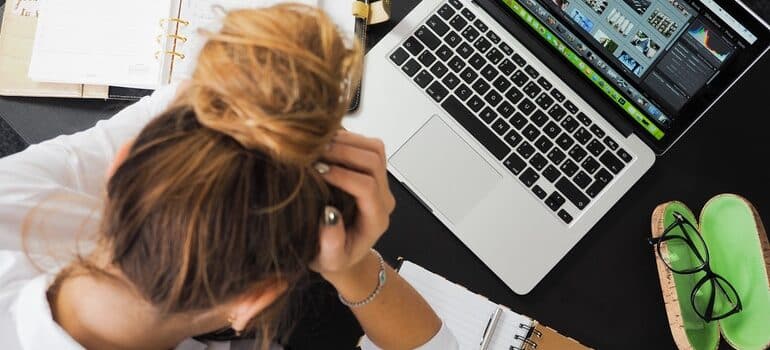 Stressed person looking at a computer screen.