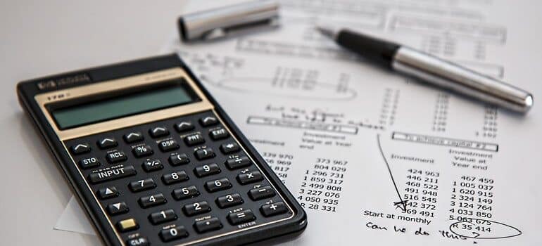 Calculator and pen on a budget plan.