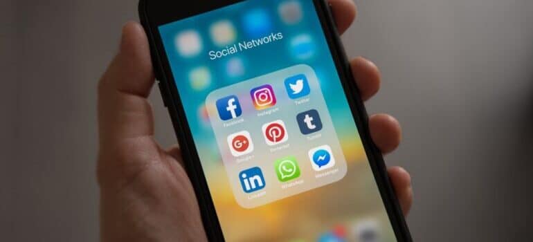 Phone displaying social media apps. Businesses are focusing their marketing on social media platforms.