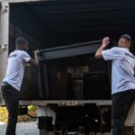A moving truck being loaded by two moving professionals | how to increase the value of your domain name