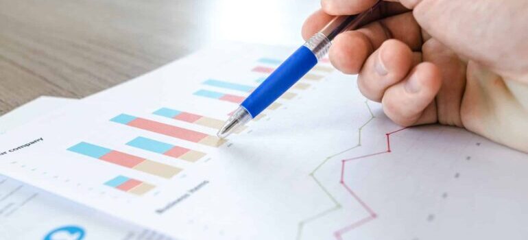 A person looking over data on a piece of paper.