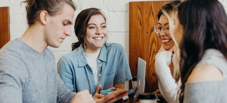 Marketing team sitting at a table and discussing ways to advertise your moving business