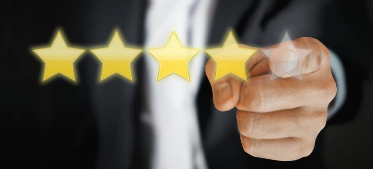 A businessperson pointing at a virtual display of five stars, symbolizing high-quality service to establish new referral partners for a moving company.