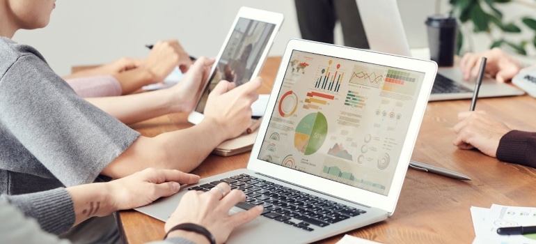 people looking at some charts on their laptops 
