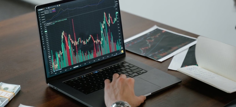 a man looking at some analysis on his laptop 