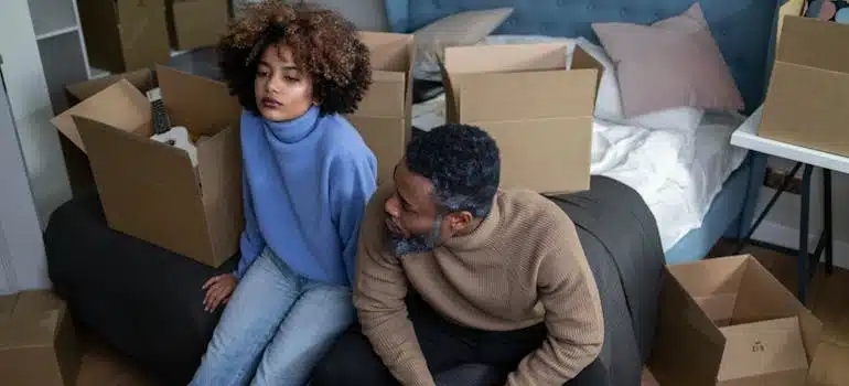 Couple packing boxes and preparing for a move