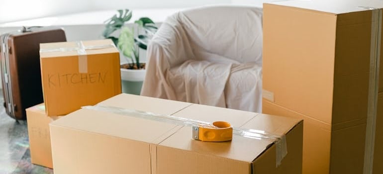 Labeled boxes packed in a living room