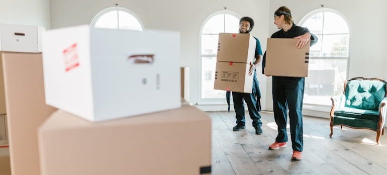 Movers carrying boxes with help from the best apps for moving available today